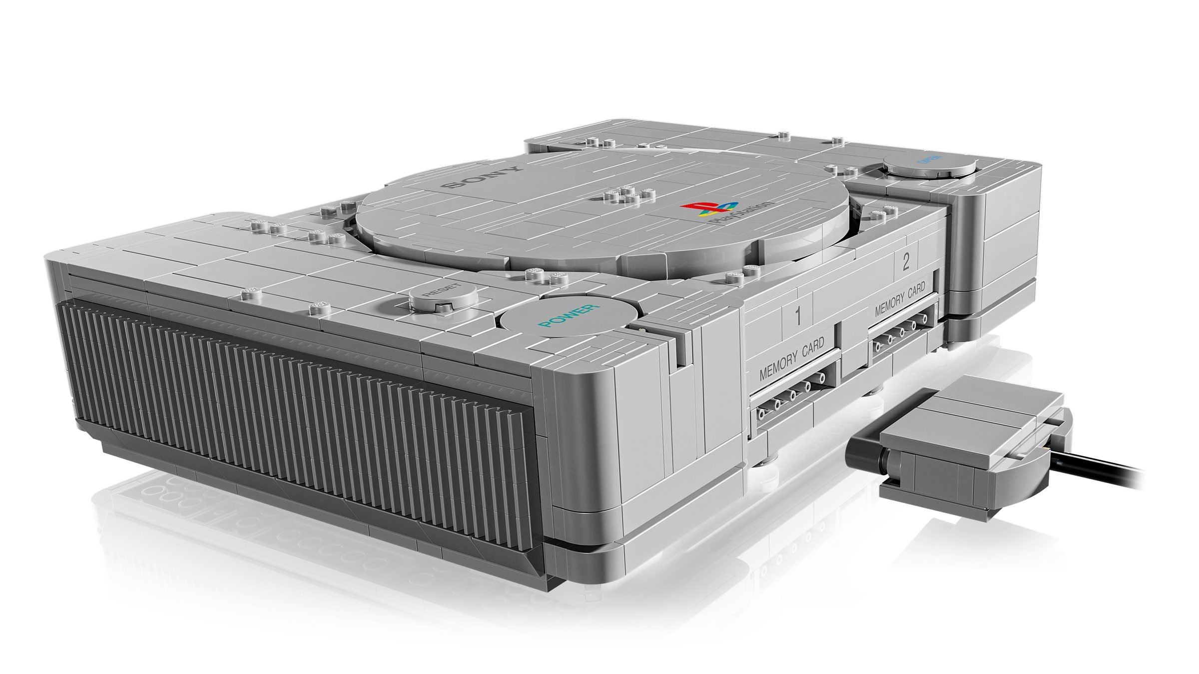 Vue arrière du LEGO PlayStation 72306, grilles d'aération nervurées et connecteur de la manette posé à côté